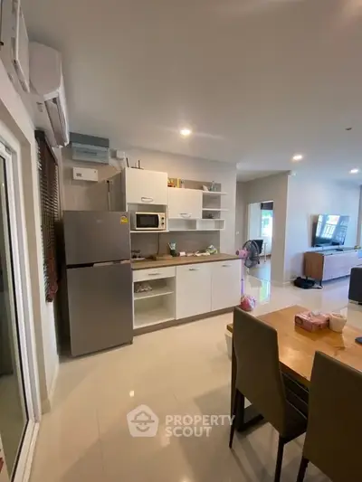 Modern kitchen with open layout and dining area in stylish apartment