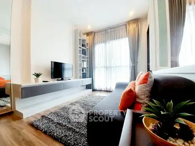 Modern living room with sleek furniture and large window, featuring stylish decor and cozy ambiance.