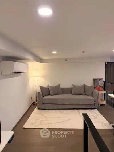 Modern living room with cozy gray sofa and stylish decor