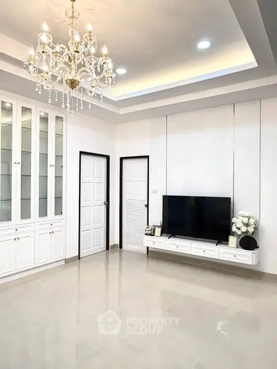 Elegant living room with chandelier and modern TV setup