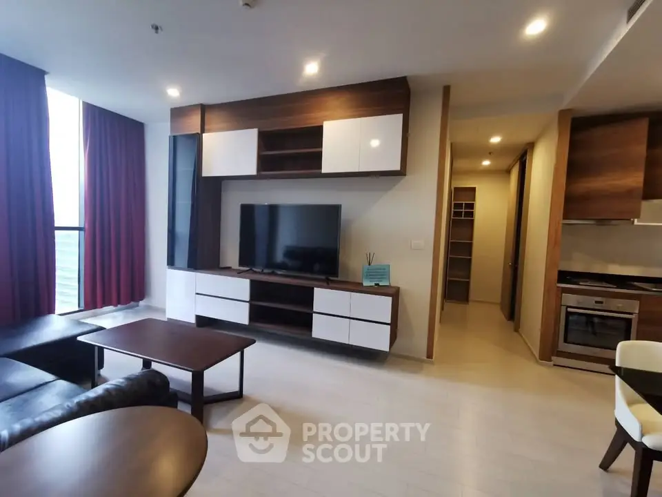Modern living room with sleek furniture and open kitchen layout