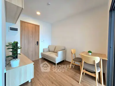 Modern living room with wooden flooring, cozy sofa, and dining area in a stylish apartment.
