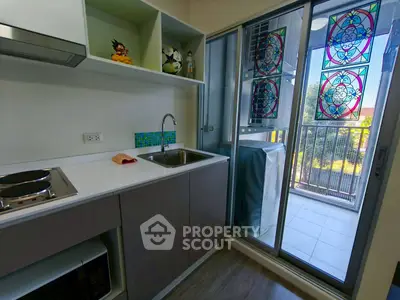 Modern kitchen with balcony view and vibrant stained glass decor