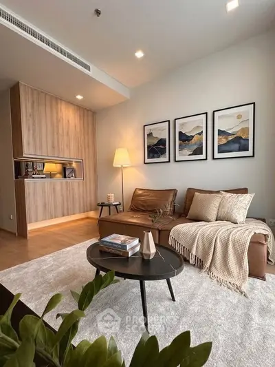 Stylish modern living room with cozy leather sofa, elegant decor, and warm lighting in a contemporary apartment.