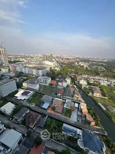 Stunning aerial view of urban landscape with modern buildings and lush greenery, perfect for real estate investment.