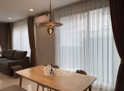 Modern living room with elegant curtains and cozy dining area