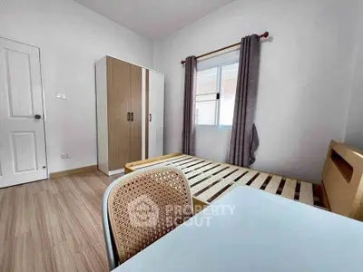 Spacious bedroom with modern furniture and natural light