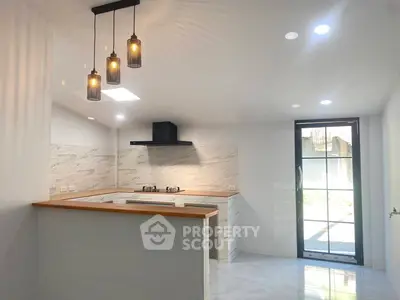 Modern kitchen with open layout and stylish lighting fixtures