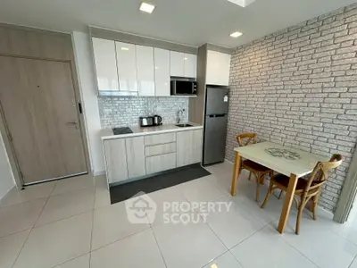 Modern kitchen with sleek cabinetry and dining area in stylish apartment