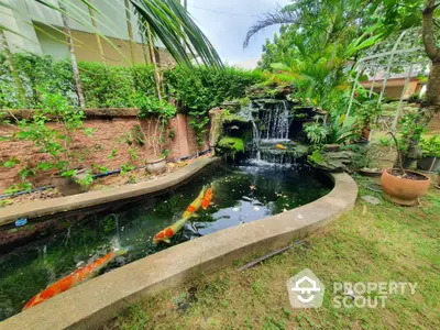 Stunning garden with koi pond and waterfall feature in lush green setting