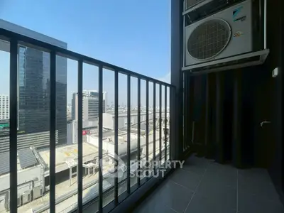 Modern balcony with city view and air conditioning unit in urban high-rise building.