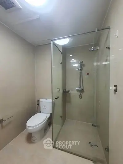 Modern bathroom with glass shower enclosure and sleek fixtures