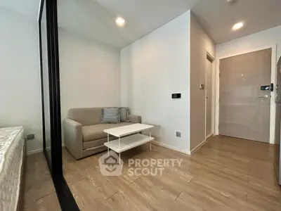 Modern minimalist living room with cozy sofa and wooden flooring