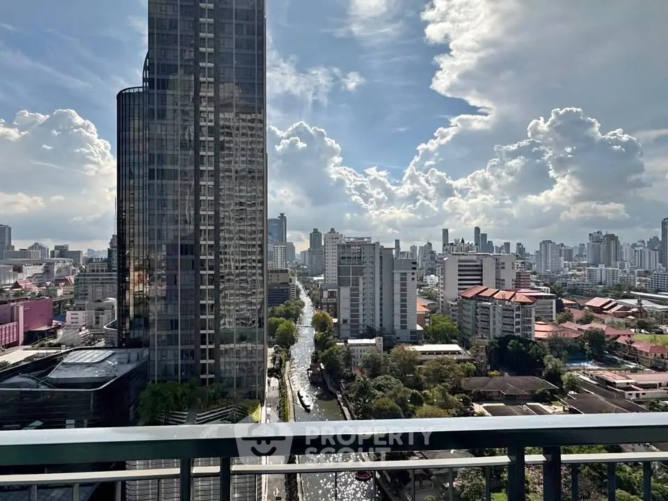 Stunning cityscape view from a high-rise balcony showcasing urban skyline and dramatic clouds.