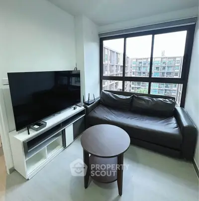 Modern living room with large window and sleek furniture