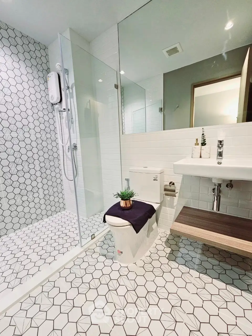 Modern bathroom with geometric tiles and glass shower enclosure