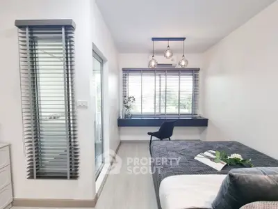 Modern bedroom with stylish decor and large window for natural light