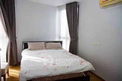 Cozy bedroom with natural light and modern decor in a stylish apartment.