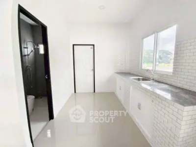 Modern kitchen with sleek countertops and ample natural light