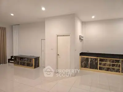Modern kitchen with sleek cabinetry and glossy tile flooring