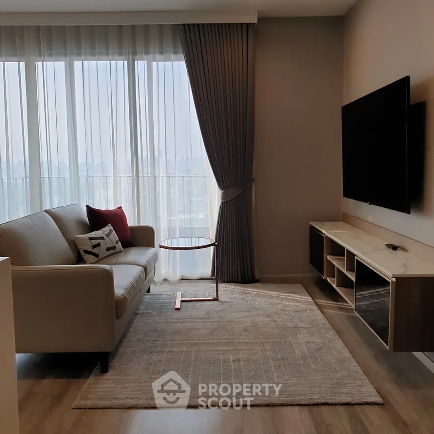 Modern living room with large window, elegant curtains, and sleek furniture