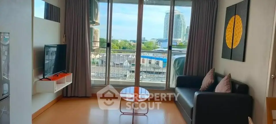 Modern living room with large windows and city view, featuring sleek furniture and stylish decor.