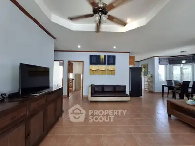 Spacious living room with ceiling fan and modern decor in a stylish home.
