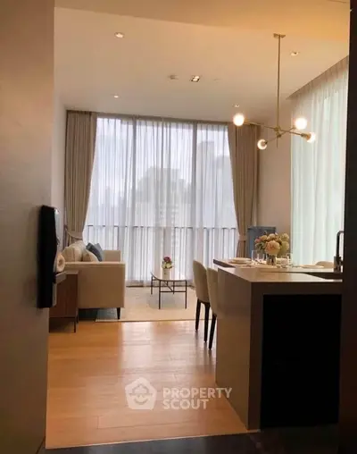 Modern open-plan living room with elegant decor and large windows offering city views.