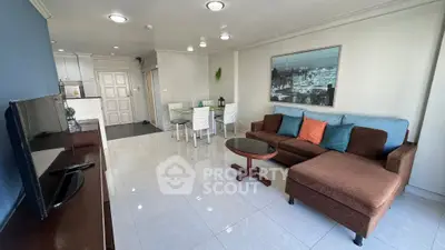 Spacious living room with modern decor and open kitchen layout