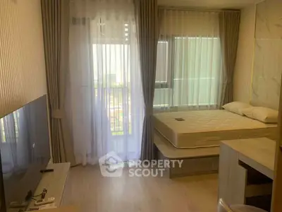 Modern bedroom with large windows and natural light, featuring a minimalist design and cozy atmosphere.