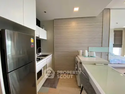 Modern kitchen with sleek appliances and compact design in a stylish apartment.