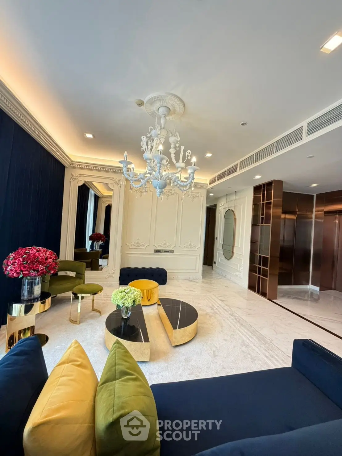 Luxurious living room with elegant chandelier and plush seating in modern apartment