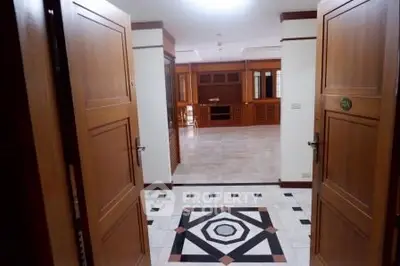 Spacious entrance leading to an elegant open living area with stylish wooden accents.