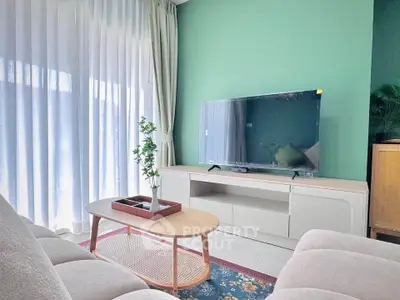 Modern living room with stylish furniture and large TV