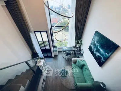 Stunning loft apartment with high ceilings and modern decor, featuring a cozy living area and balcony view.