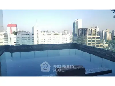 Stunning rooftop pool with panoramic city skyline views, perfect for relaxation and luxury living.