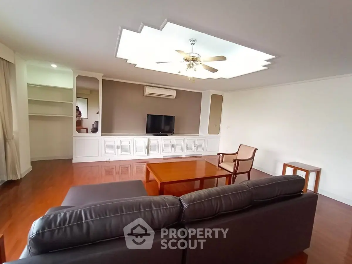 Spacious living room with elegant ceiling design and modern furniture
