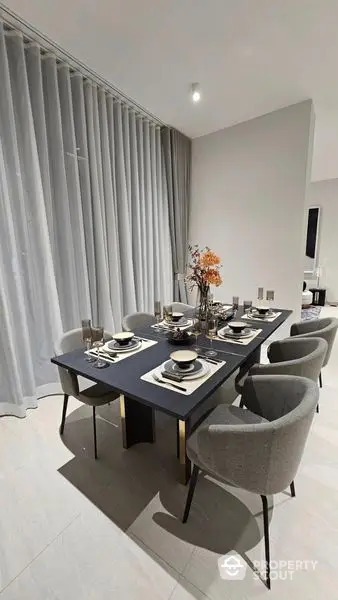 Elegant dining area with modern furniture, sleek design, and tasteful decor, perfect for intimate dinners and social gatherings.