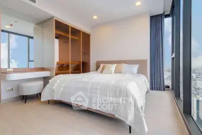 Luxurious bedroom with floor-to-ceiling windows offering stunning city views, featuring modern decor and ample storage.