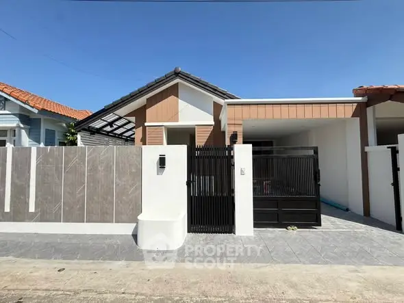 Charming modern single-story house with gated entrance and stylish facade in a serene neighborhood.