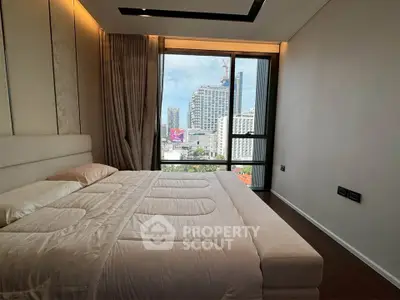 Luxurious bedroom with city view, featuring elegant decor and large windows for natural light.