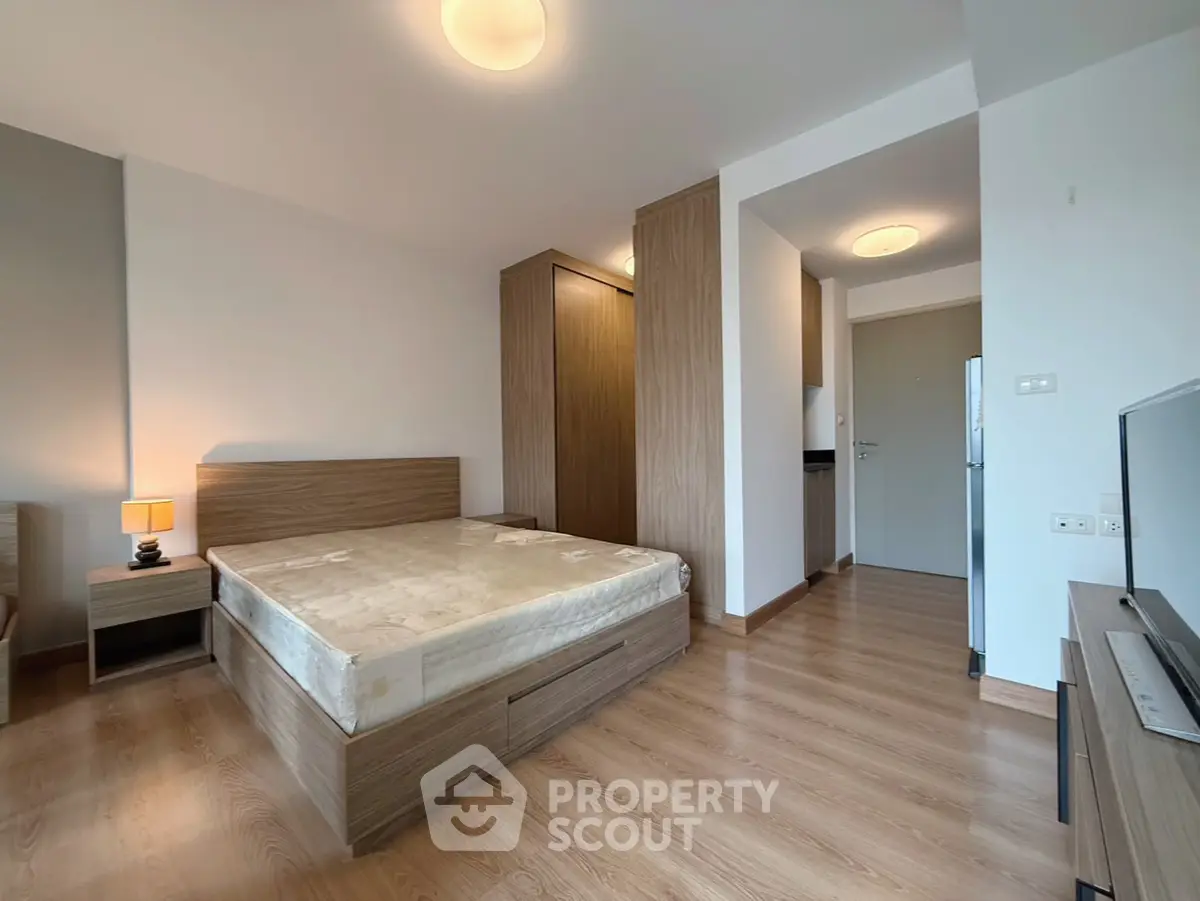 Modern bedroom with wooden flooring and stylish furniture