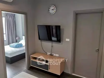 Modern living room with wall-mounted TV and sleek furniture