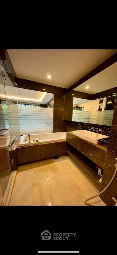 Luxurious modern bathroom with elegant marble finishes and spacious bathtub