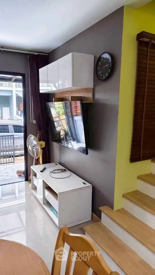 Modern living room with wall-mounted TV and stylish decor