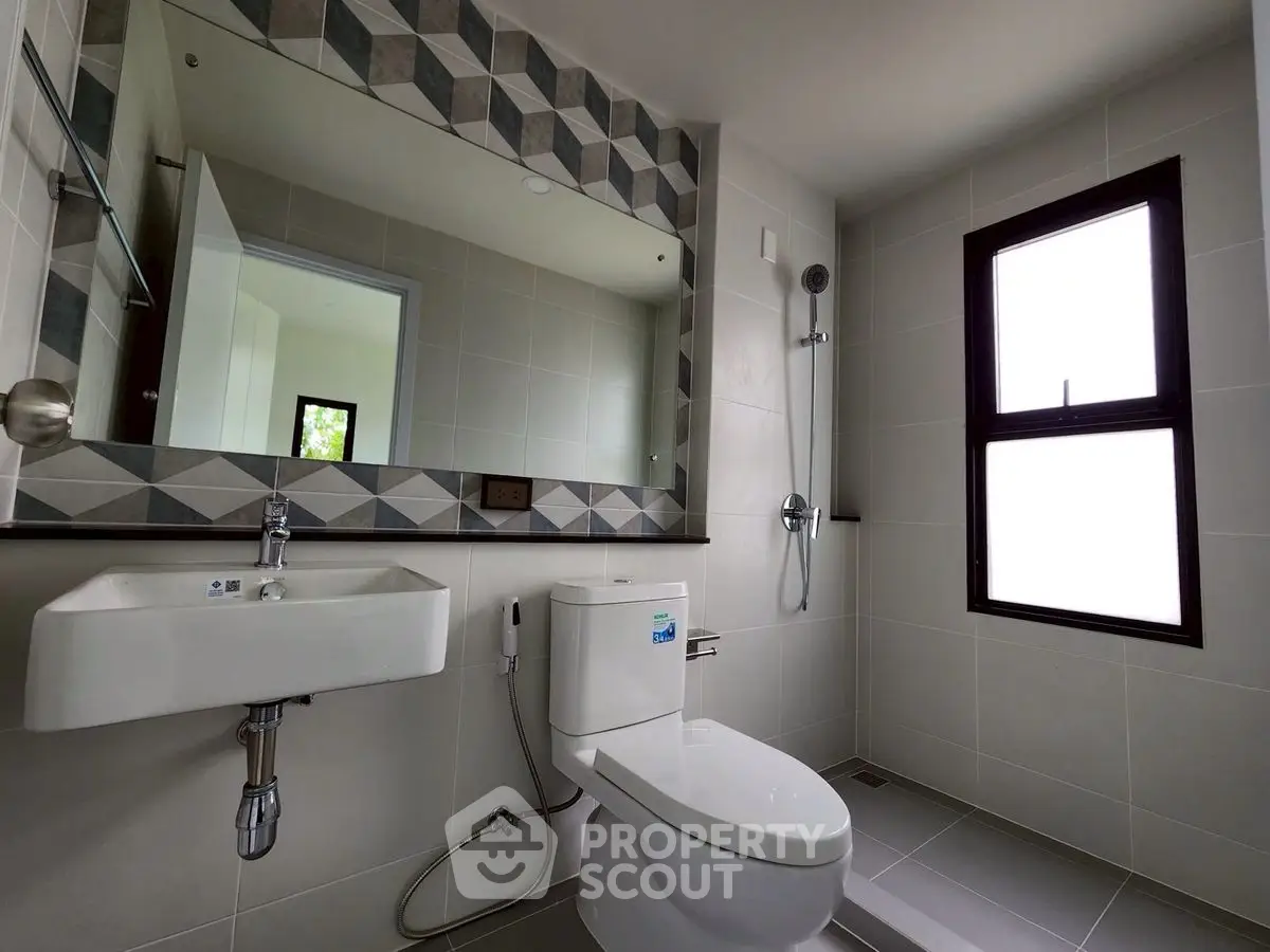 Modern bathroom with sleek fixtures and geometric tile accents