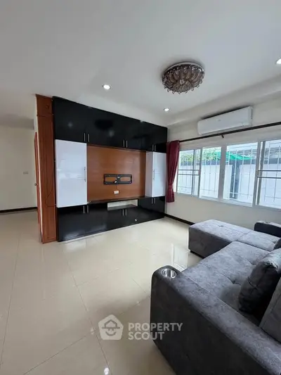 Spacious living room with modern decor and large windows for natural light.