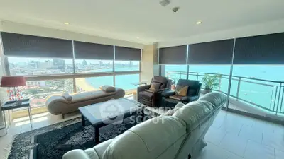 Luxurious living room with panoramic ocean view and elegant furnishings in high-rise apartment.