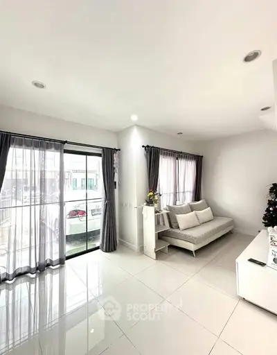 Bright and spacious living room with modern decor and large windows for natural light.