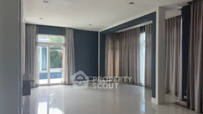 Spacious modern living room with pool view and elegant curtains